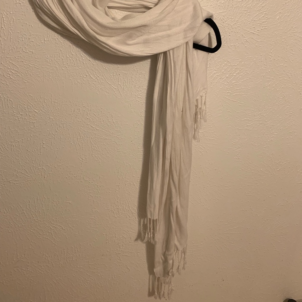 White scarf with cute tassels on each end.